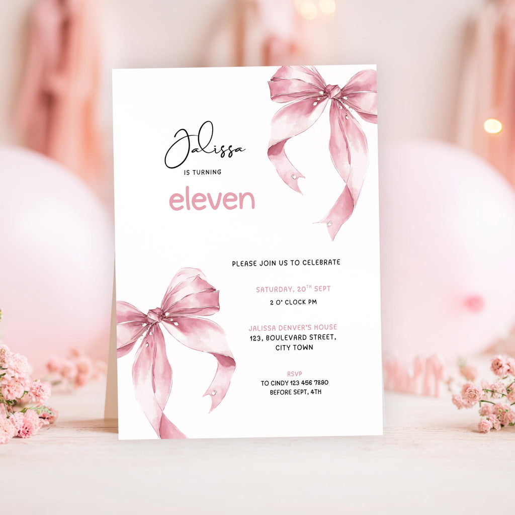 11th birthday Invitation card with pink ribbons and floral decorations on a blurred background