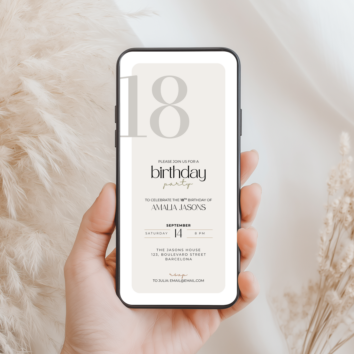 Hand holding a phone displaying a 18th birthday party invitation with Canva branding.