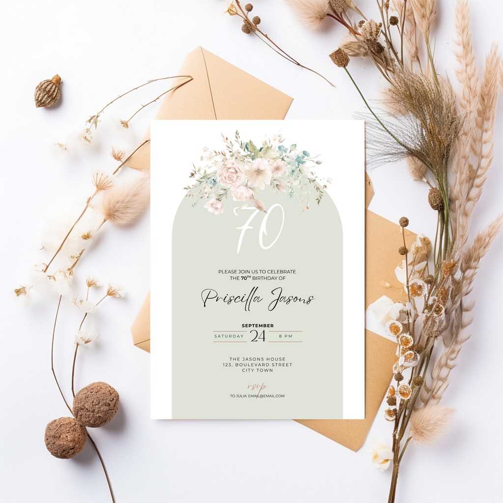 Invitation card with floral design and envelope on a white background with dried plants.
