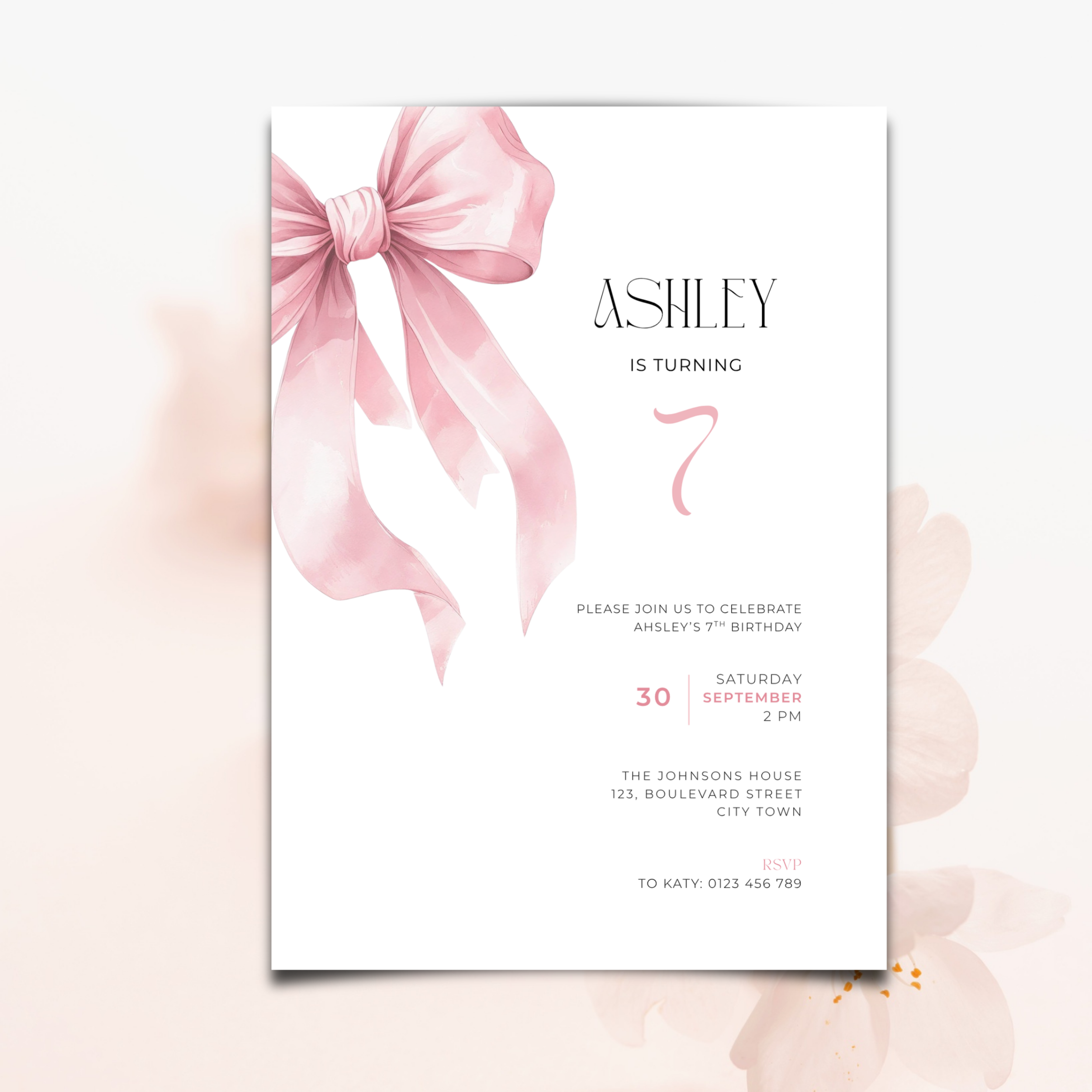 A vertical birthday invitation card with a large soft pink watercolor bow on the left side, black serif text reading 'ASHLEY IS TURNING' and a large pink number 7, shown on a pale blush background.
