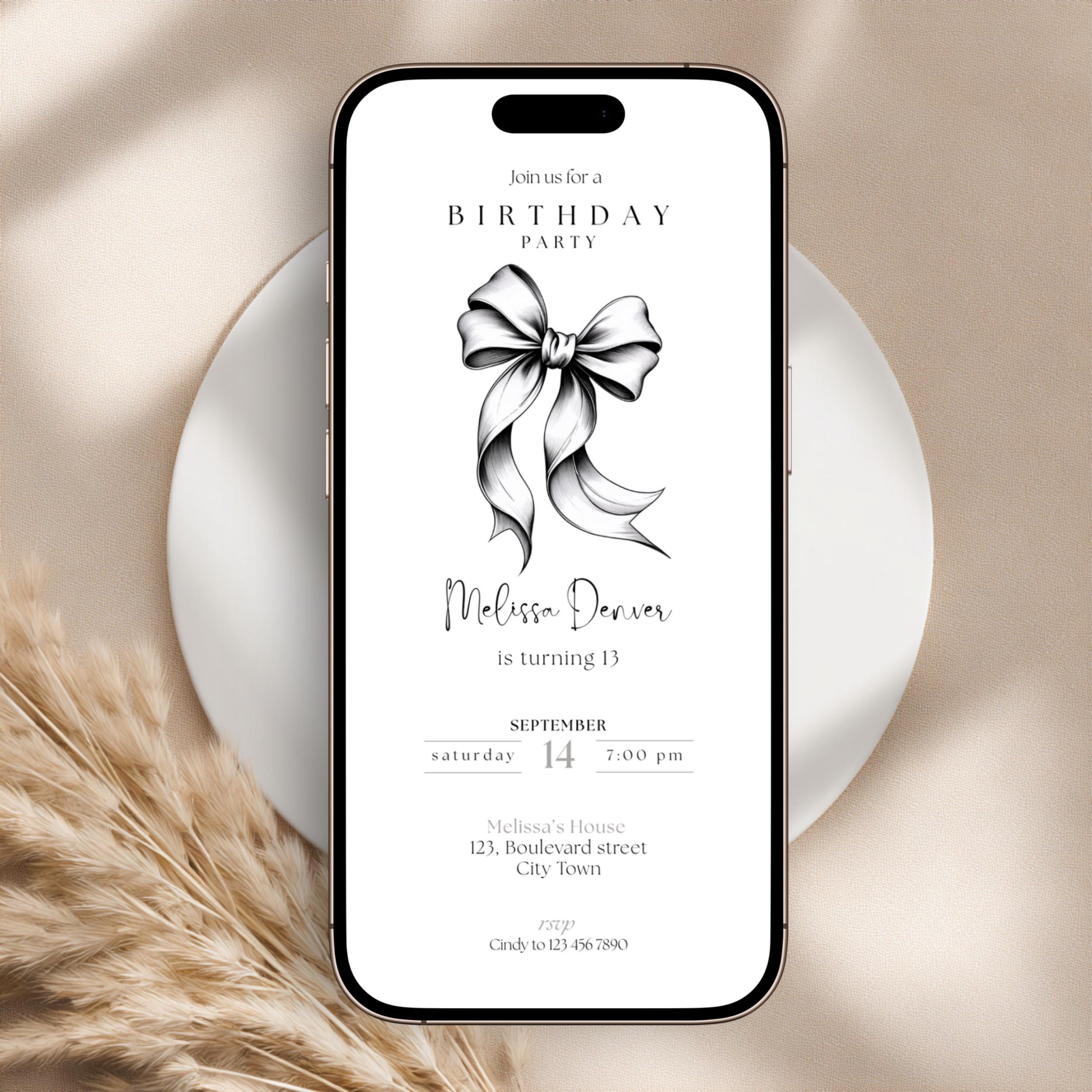 Phone displaying a 13th birthday party invitation with a bow graphic on a beige background
