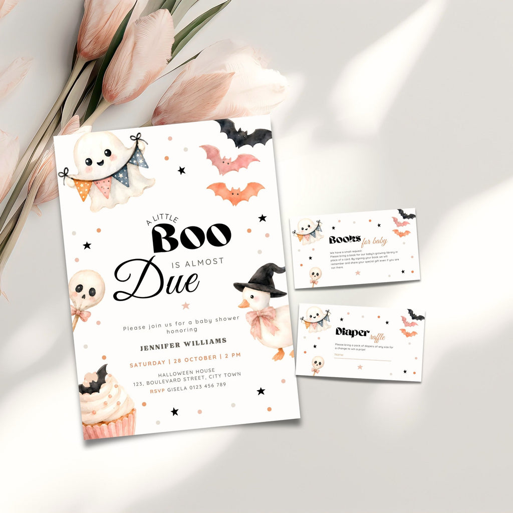 A Halloween little boo baby shower invitation set styled on a light surface with pink tulips. The main invitation card reads 'A Little Boo Is Almost Due' with cute ghost, bat, witch, and cupcake illustrations.