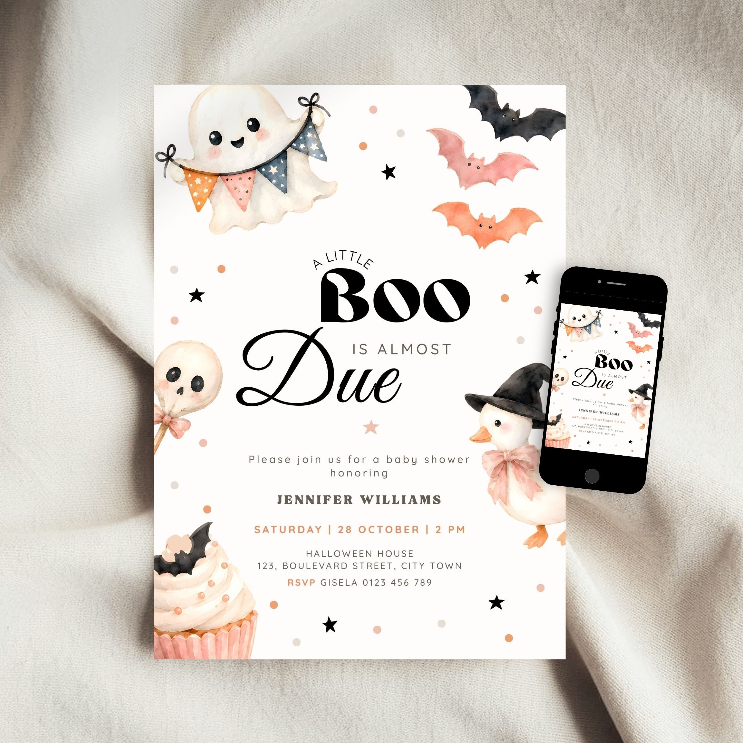 A Halloween little boo baby shower invitation card with cute ghost, bat, and pumpkin illustrations, shown on a light fabric background next to a smartphone displaying the matching digital invitation.