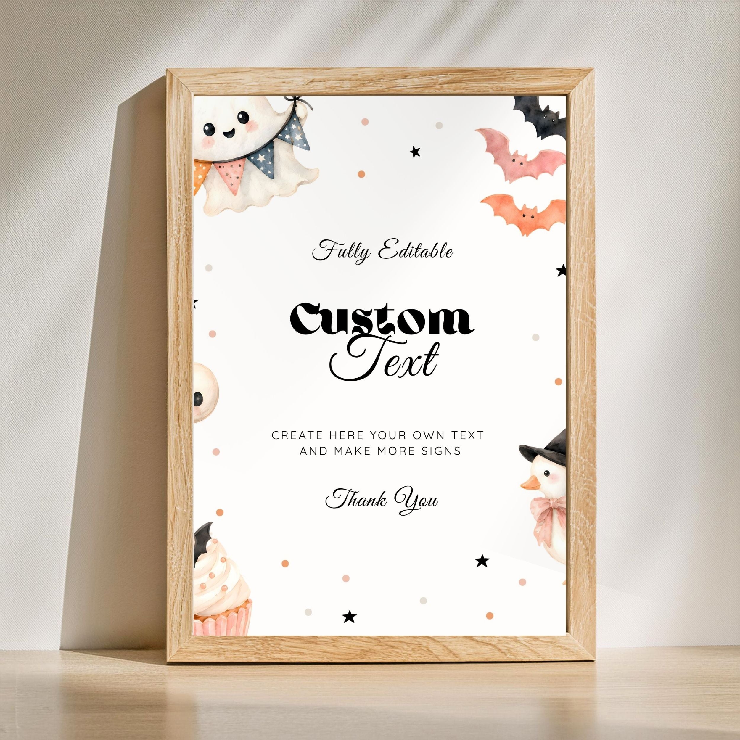 A framed editable sign template with a light wood frame, featuring Halloween illustrations like a ghost, bat, cupcake, and snowman, plus customizable text on a white background.