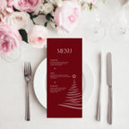 A vertical burgundy christmas menu card with white text and a white Christmas tree illustration, styled on a white plate with silver cutlery and pink flowers in the background.