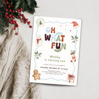 A festive Christmas-themed birthday invitation card styled on a light gray textured surface with a knitted cream sweater and red berries in the corner. The card features colorful text reading 'Oh What Fun' with illustrations of a snowman, gingerbread man, Santa hat, stocking, and gift.