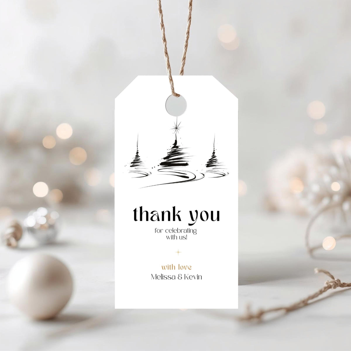 Minimal Christmas thank you gift tag template with a black tree illustration and twine loop, on a blurred holiday background
