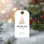 Golden Christmas thank you gift tags attached to holiday gifts