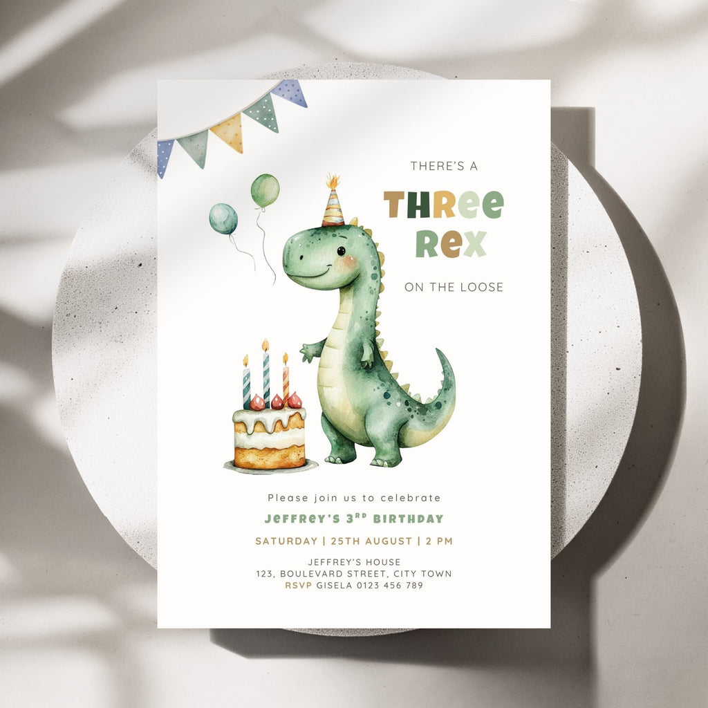 A watercolor-style dino 3rd birthday invitation card for a three-year-old child, featuring a green dinosaur wearing a party hat next to a birthday cake, displayed on a white ceramic plate with soft shadows.