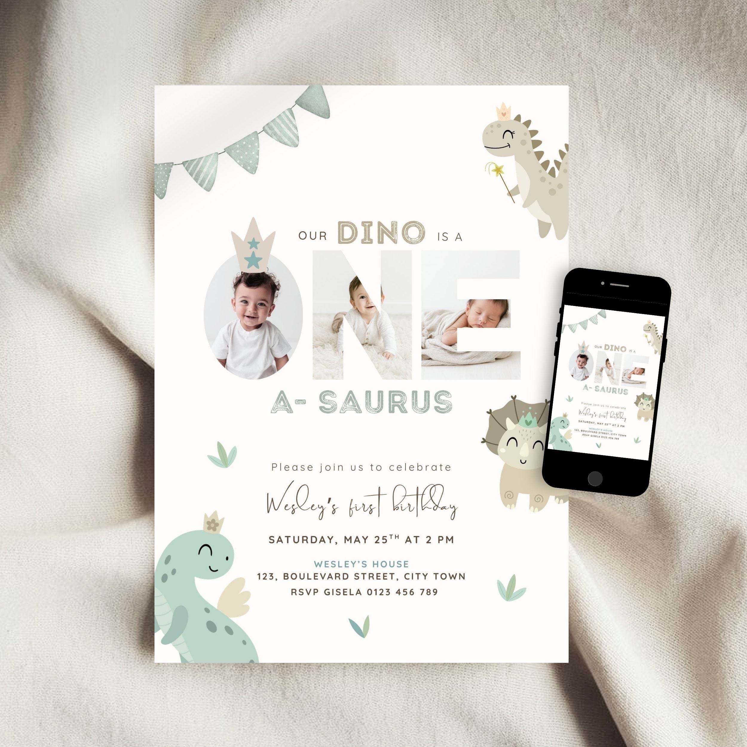 A baby dinosaur-themed first birthday invitation card displayed on a soft beige fabric background, with a smartphone showing the digital version of the invitation beside it.