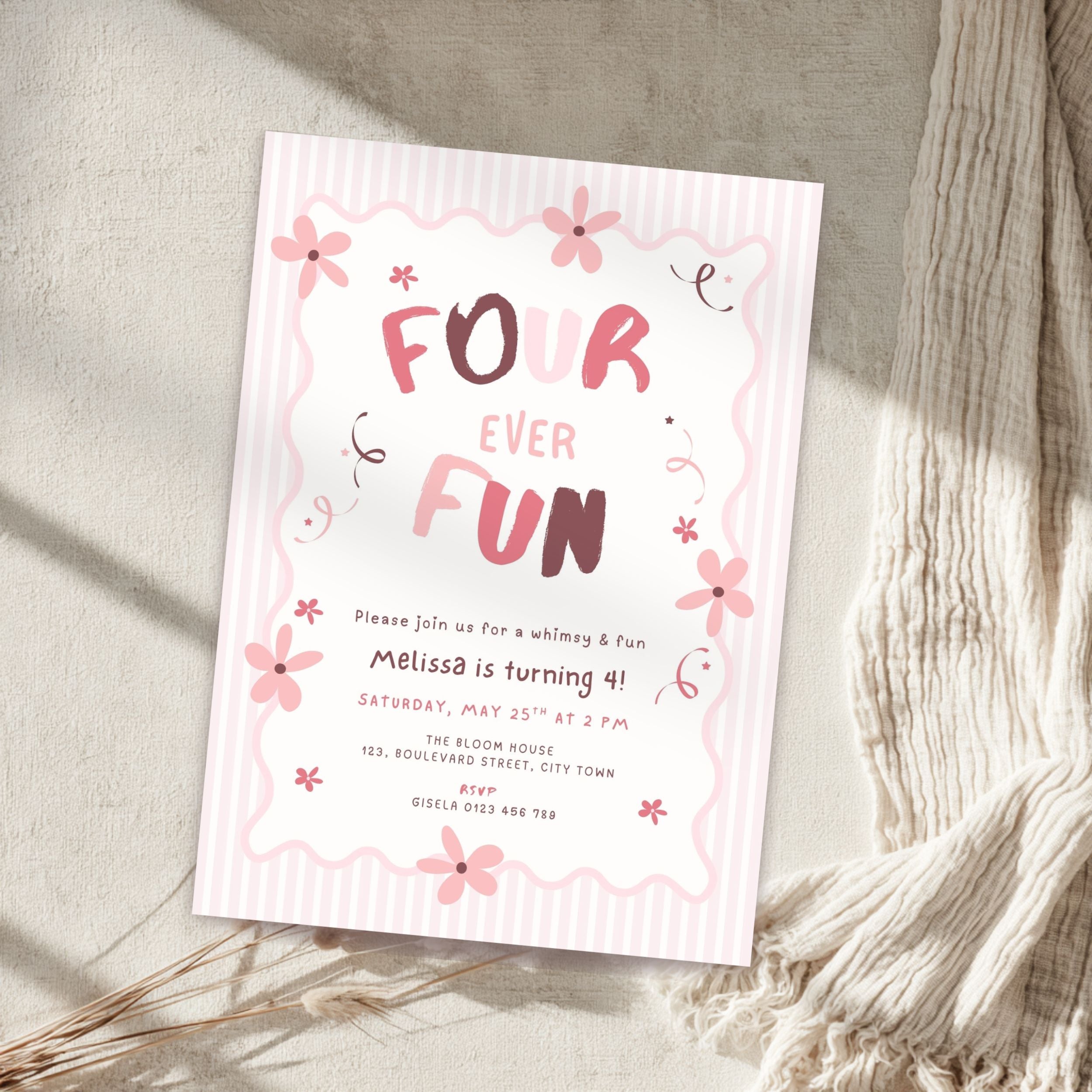 A pink and white striped 'Four Ever Fun' birthday invitation card styled on a textured beige surface with a cream knit blanket and dried grasses.