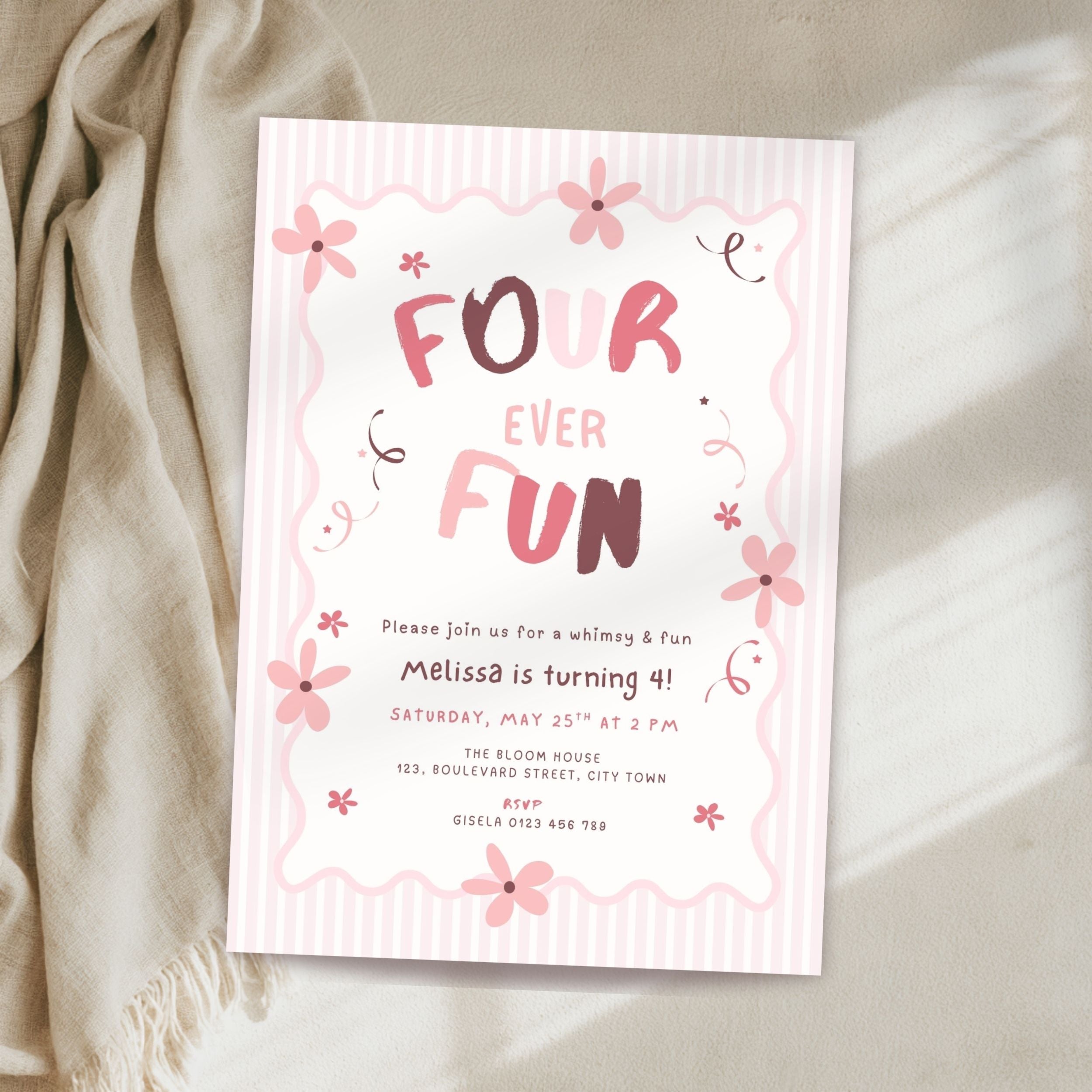 A pastel pink and white striped 'Four Ever Fun' 4th birthday invitation card styled on a beige fabric surface next to a cream-colored throw blanket.