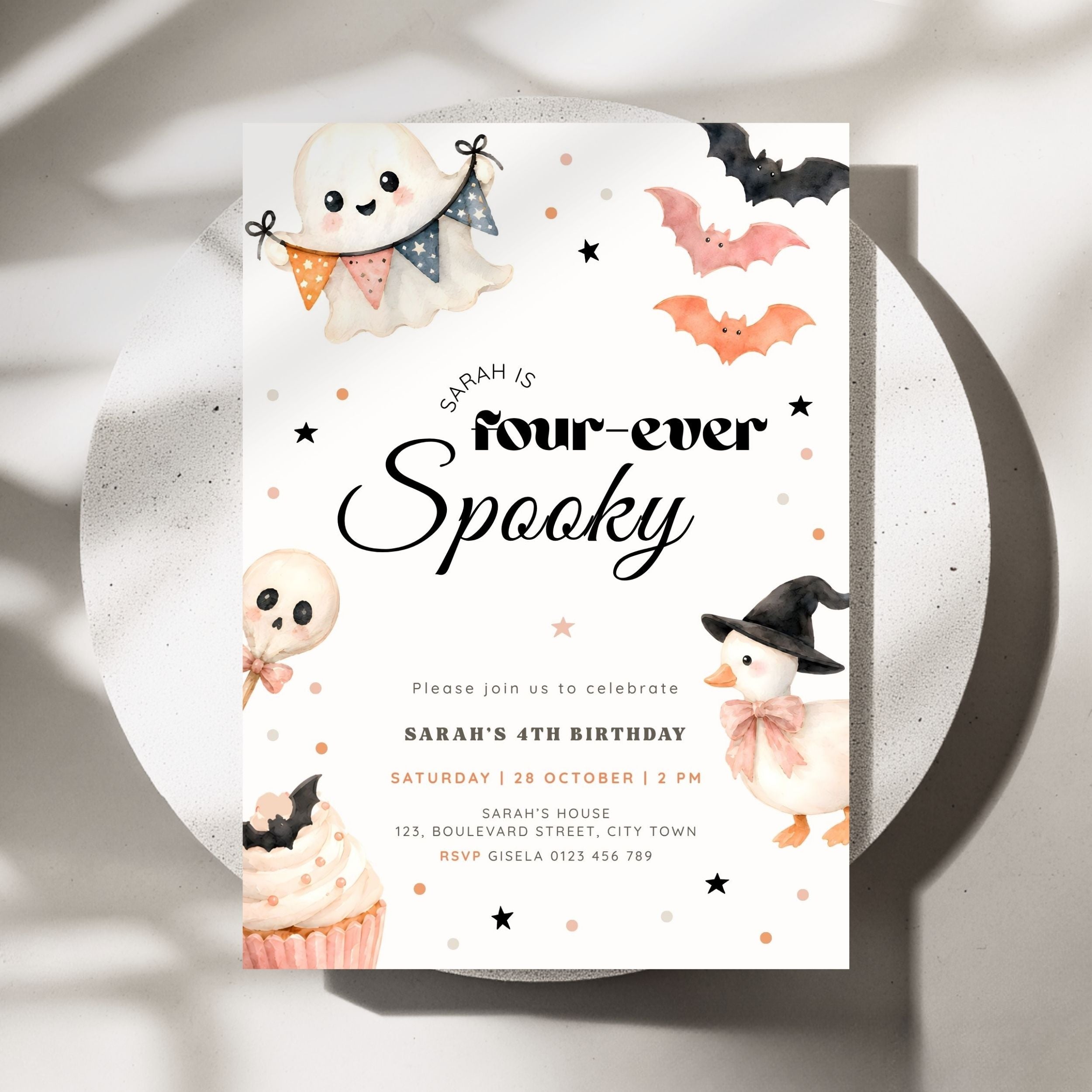 A Halloween-themed birthday invitation card for Sarah's 4th birthday, styled on a round white plate with soft shadows. The card features cute watercolor illustrations of a ghost, a bat, a skull, a witch's hat, and a cupcake, with the text 'Sarah is four-ever Spooky'.