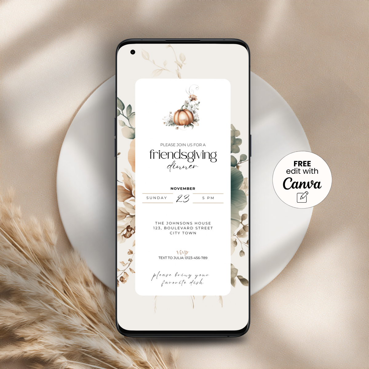 Floral Friendsgiving invitation template with pumpkin and leaves on a phone screen, styled on a white plate