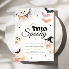 A Halloween-themed birthday invitation card for Sarah's 2nd birthday, styled on a white ceramic plate with soft shadows. The card features cute watercolor illustrations of a ghost, a pumpkin, a skull, a cupcake, and bats on a white background with black and orange text.