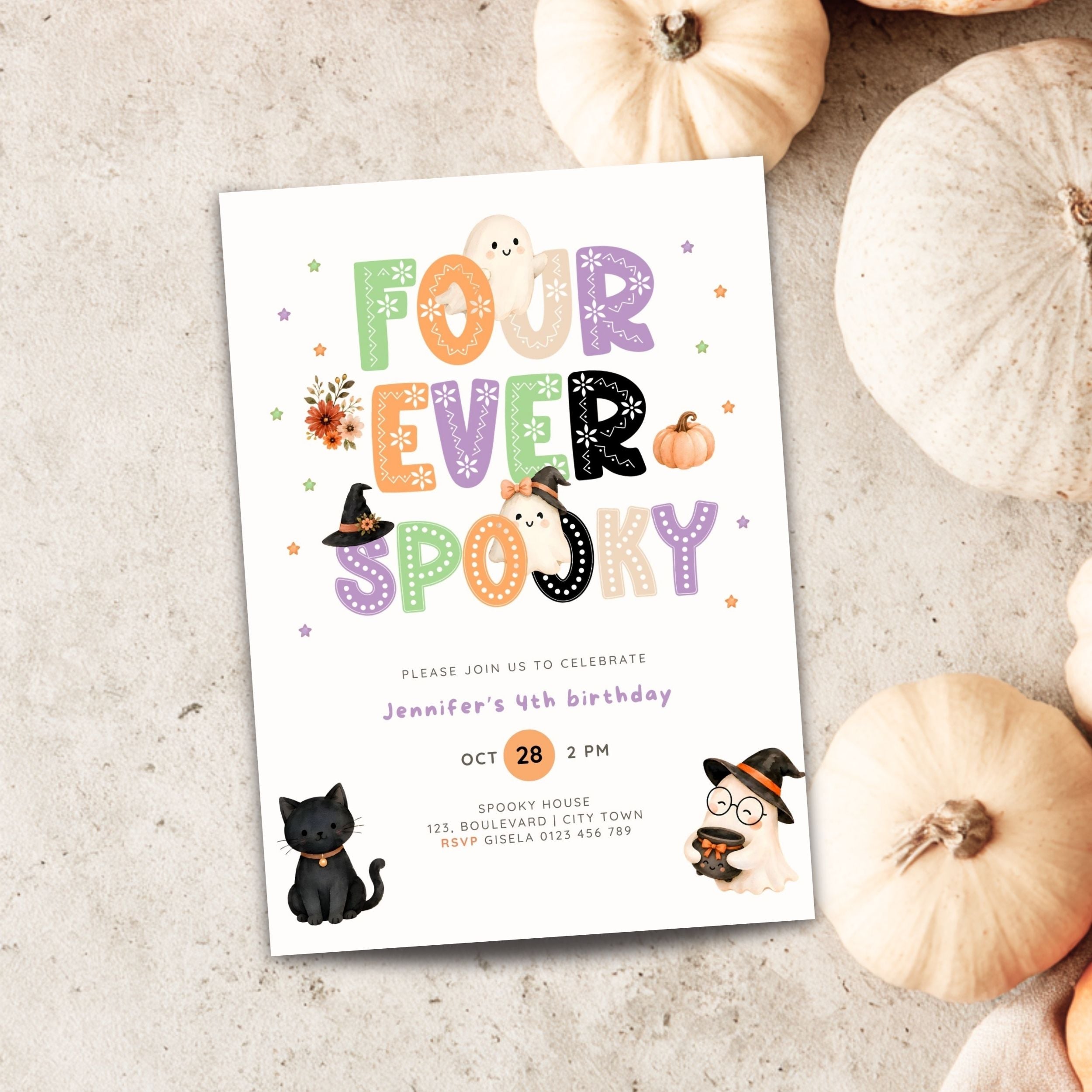 A Halloween-themed birthday invitation card styled in a flat-lay on a light textured surface with decorative pumpkins around it. The card reads 'FOUR EVER SPOOKY' in colorful decorative letters and includes cute illustrations of a ghost, witch hat, pumpkin, black cat, and a ghost in a witch hat.