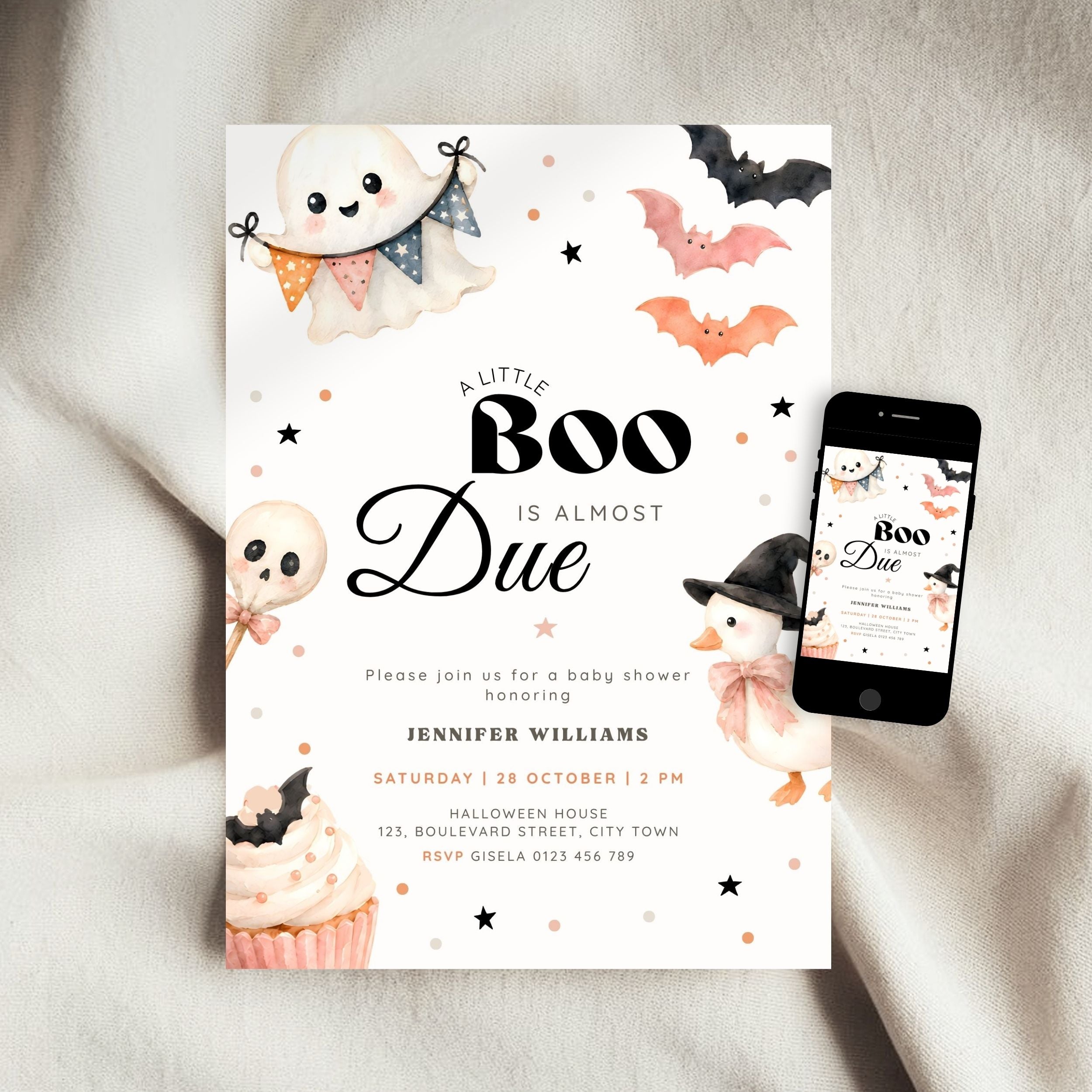 A Halloween little boo baby shower invitation card with cute ghost, bat, skull, and cupcake illustrations, shown on a white fabric background next to a smartphone displaying the same design.