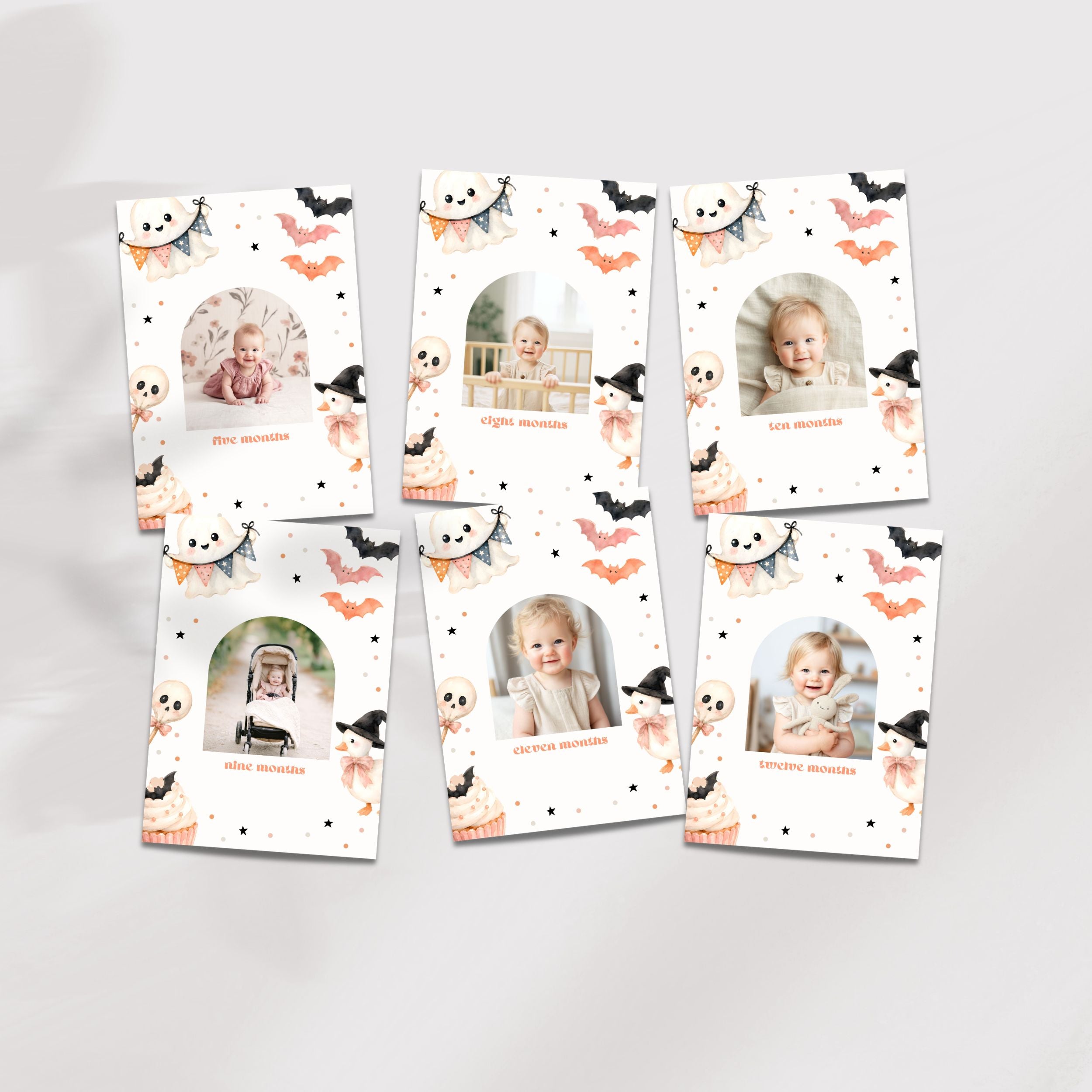 Six Halloween-themed baby milestone photo cards arranged on a light gray background. The cards feature a white background decorated with cute illustrations of bats, ghosts, witches, pumpkins, and spiderwebs, with individual baby photos and names printed on each card.