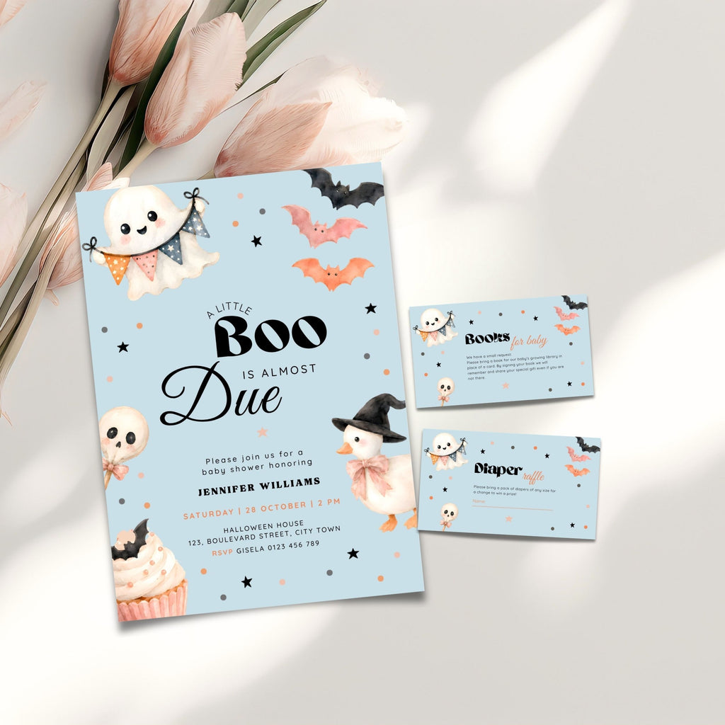 A blue halloween little boo baby shower invitation set with a light blue invitation card and two matching RSVP cards, styled on a white surface with pink tulips and soft shadows.