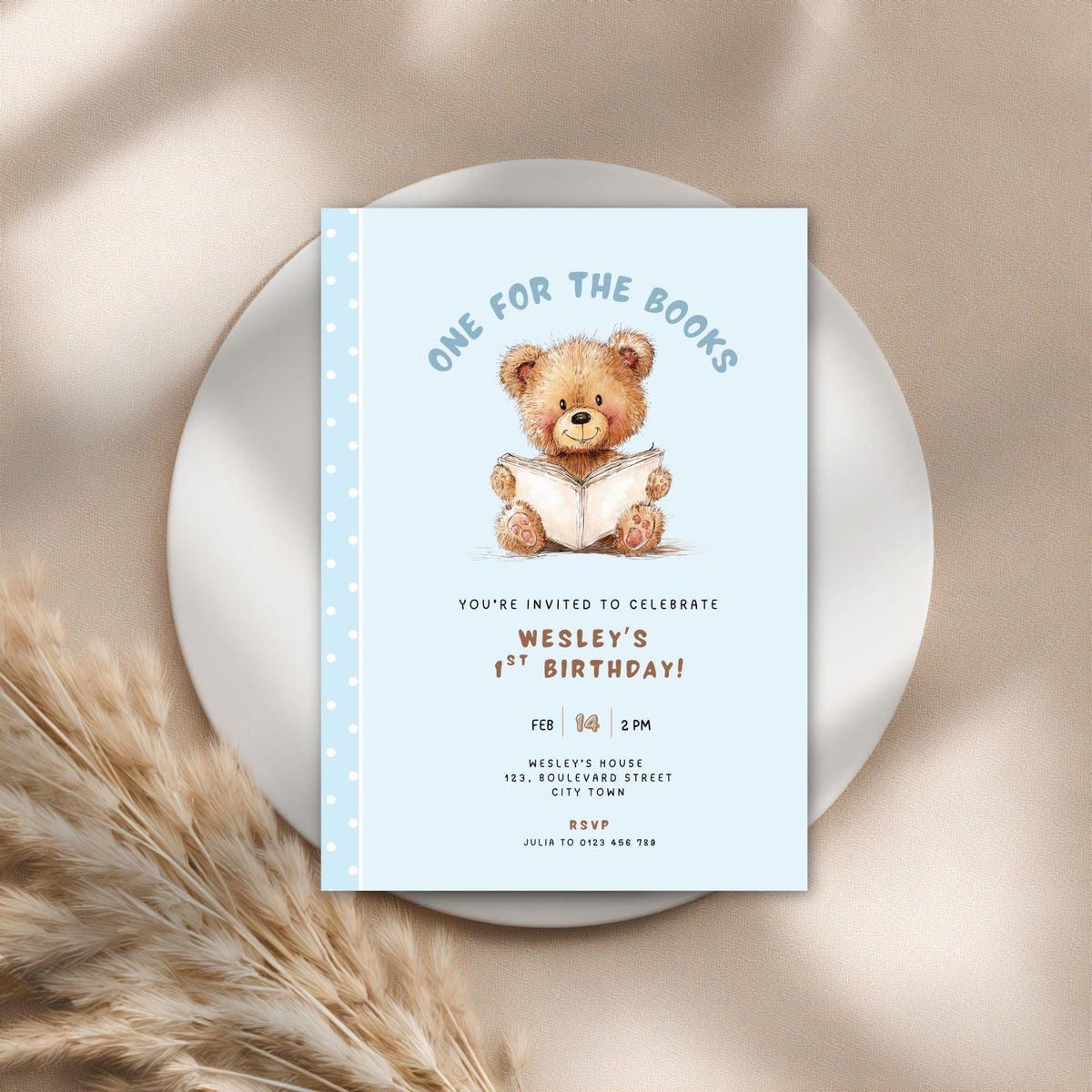 Close-up of teddy bear illustration on blue 1st birthday invitation