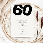 bold 60th birthday invitation card on a textured surface with decorative elements