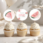 Three watermelon-themed cupcake toppers displayed on top of frosted cupcakes. The center topper is a round white design with the text 'MELISSA ONE in a melon' and small watermelon illustrations, while the side toppers are semi-circular watermelon slices with green rinds and pink flesh.