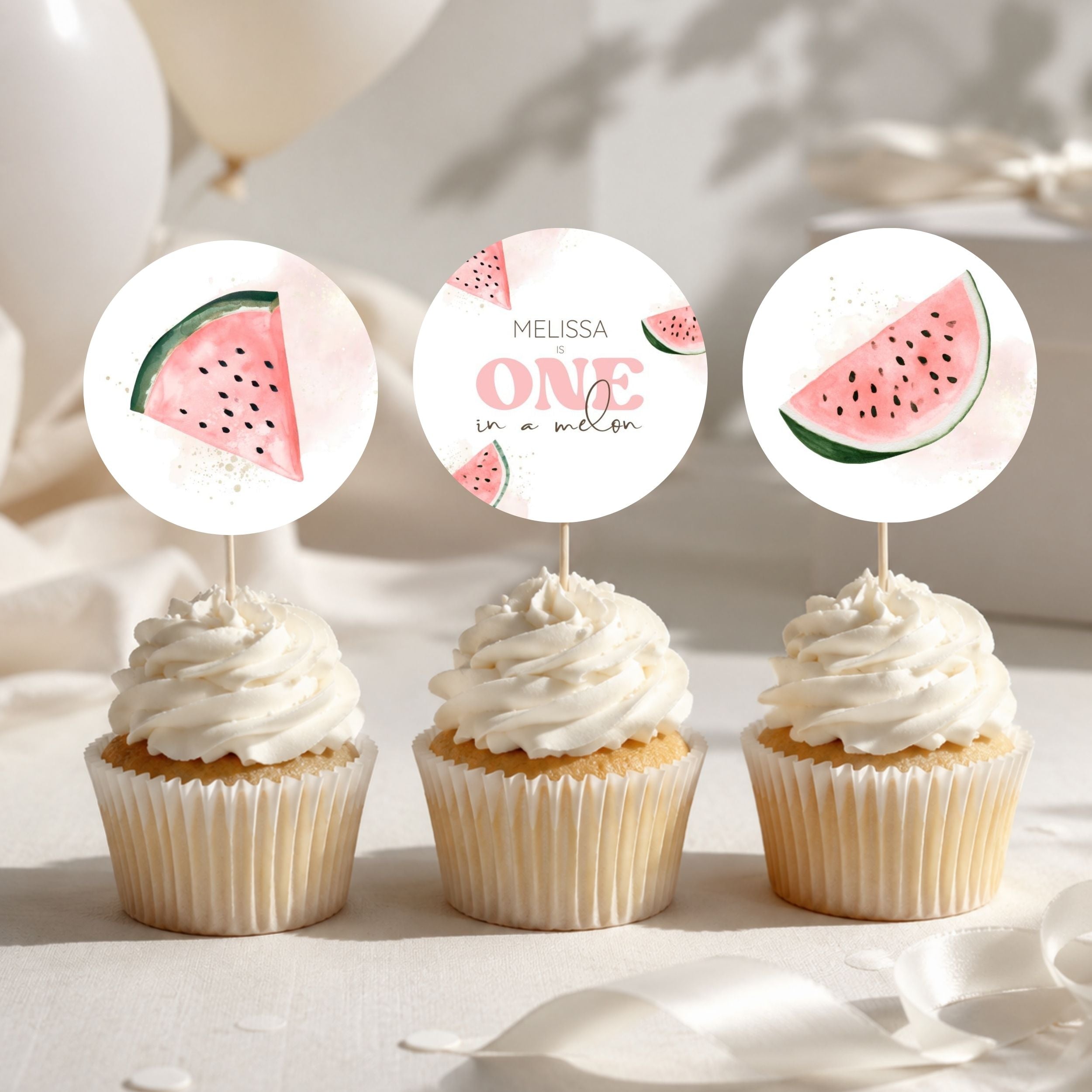 Three watermelon-themed cupcake toppers displayed on top of frosted cupcakes. The center topper is a round white design with the text 'MELISSA ONE in a melon' and small watermelon illustrations, while the side toppers are semi-circular watermelon slices with green rinds and pink flesh.
