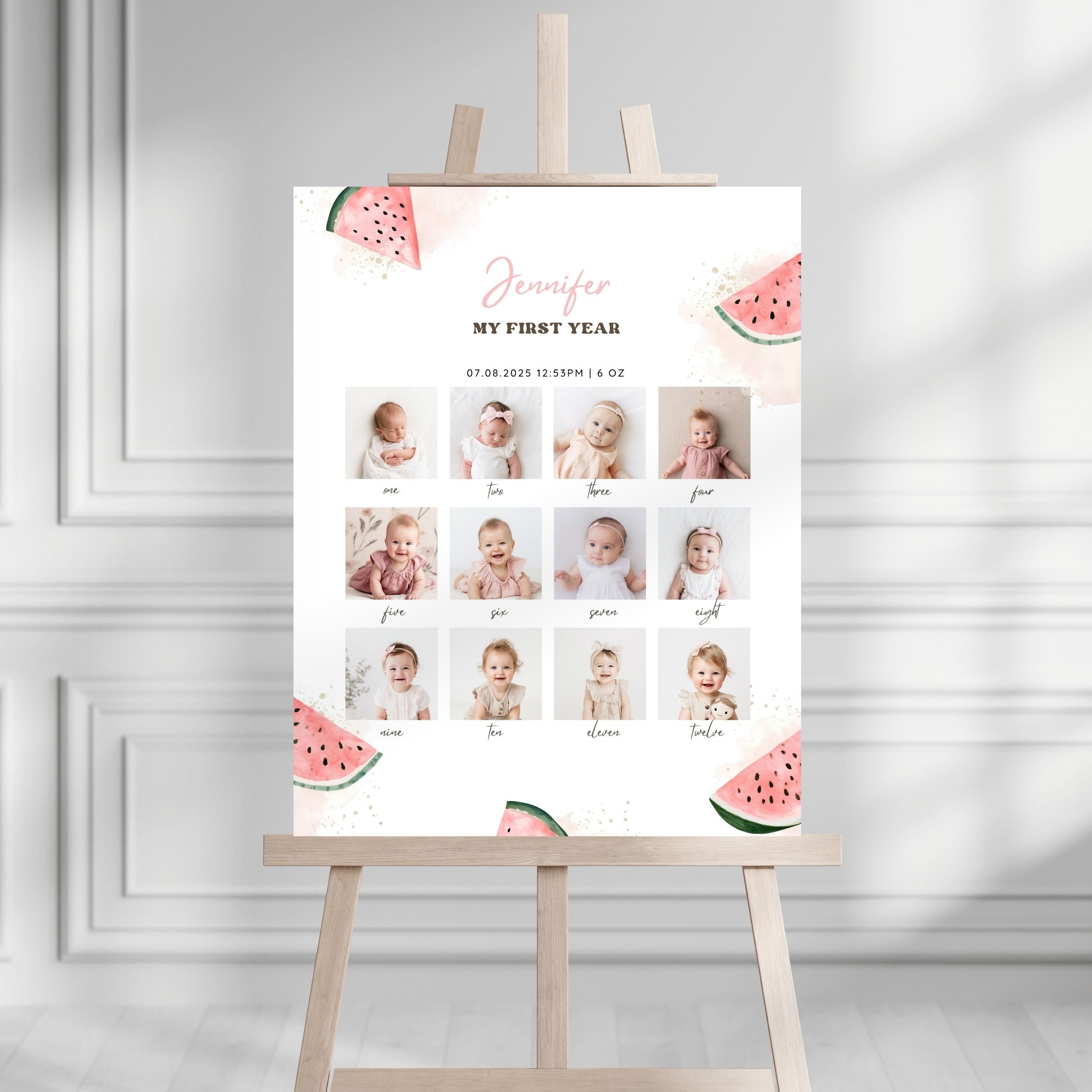 A personalized baby milestone sign on an easel, featuring watermelon illustrations and a grid of baby photos with names and ages, set against a white paneled wall background.