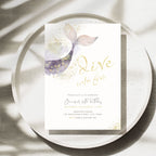 A square birthday invitation card featuring a watercolor mermaid tail design in purple, pink, and gold, with gold script text reading 'Dive into five' and black event details below, styled on a speckled white plate with soft leaf shadows.