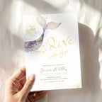 A hand holds a white 'Dive into Five' mermaid-themed birthday invitation card featuring a purple and gold watercolor mermaid tail, gold glitter accents, and gold foil-style lettering, set against a softly lit white fabric background.