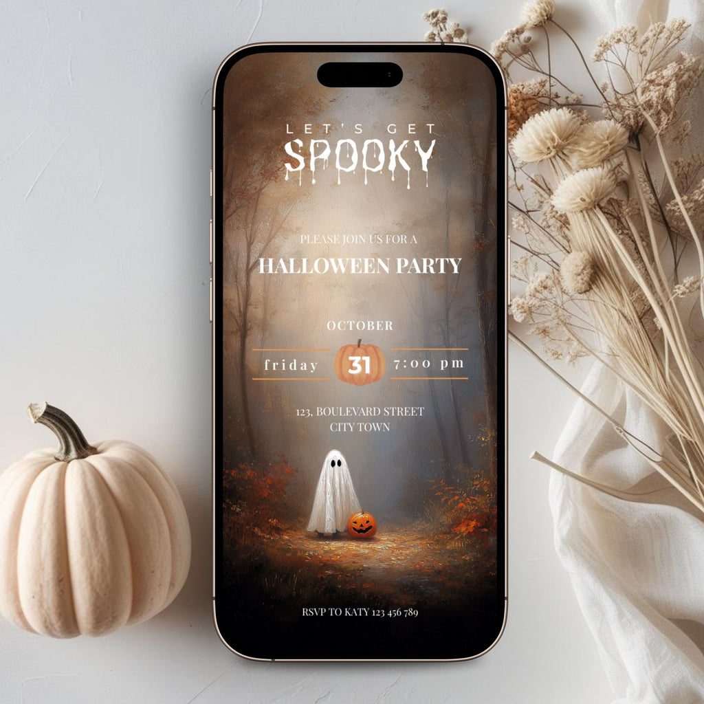 A smartphone displaying a Halloween party invitation template, styled in a flat lay with a small white pumpkin, dried flowers, and a white fabric backdrop.