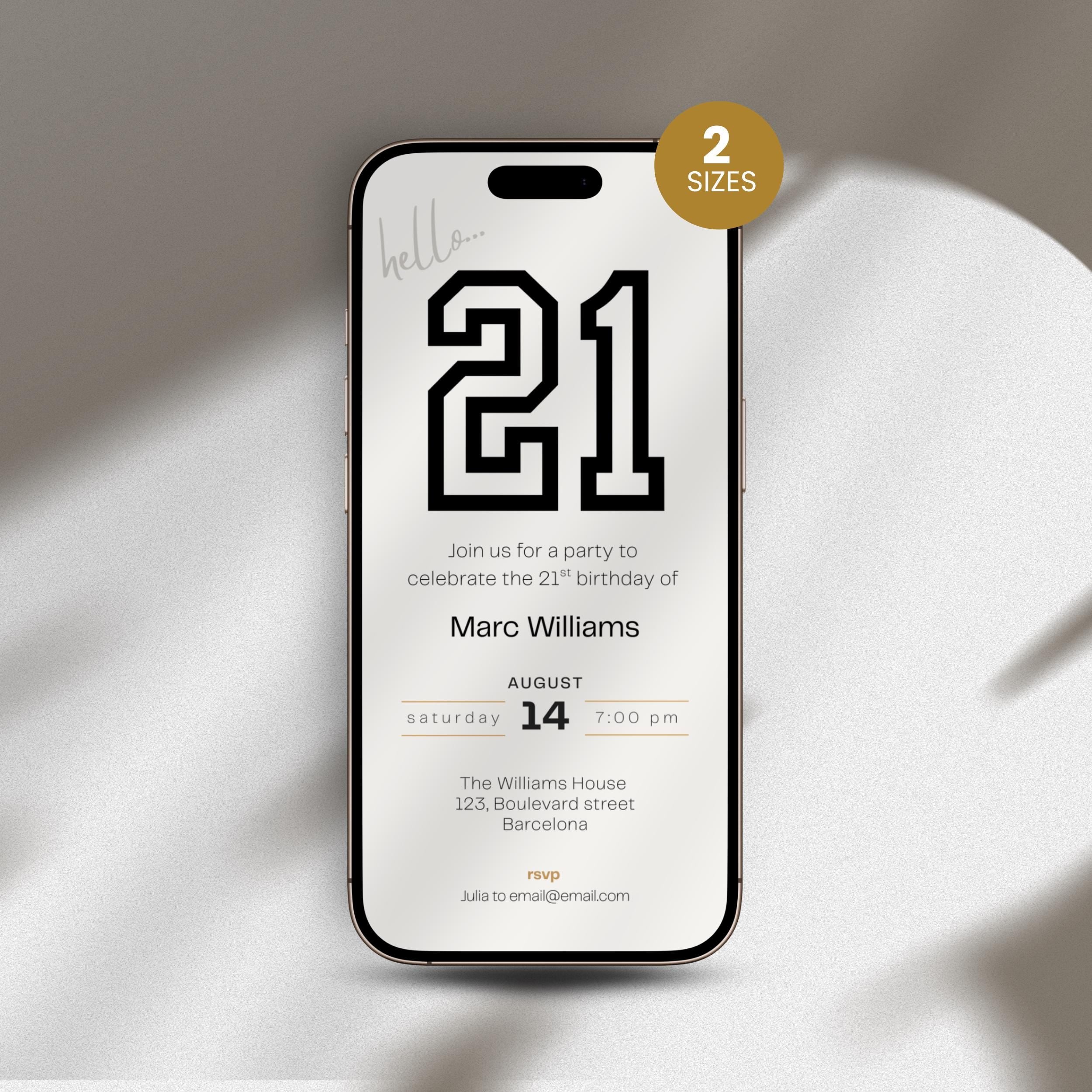 Phone with 21st birthday invitation on a white surface
