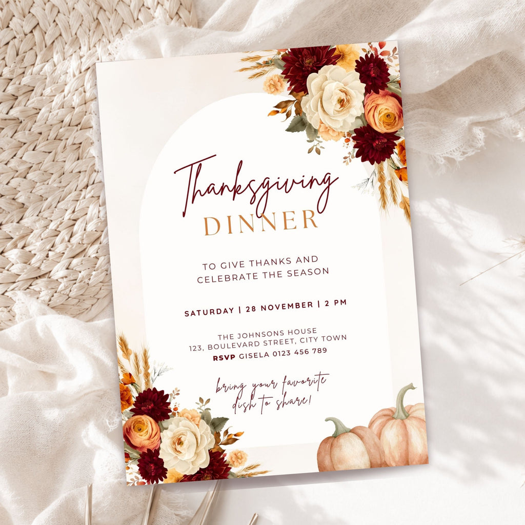 Thanksgiving dinner invitation template with burgundy and orange floral arrangements, pumpkins, wheat accents, elegant typography, and autumn-inspired details on a cream background.
