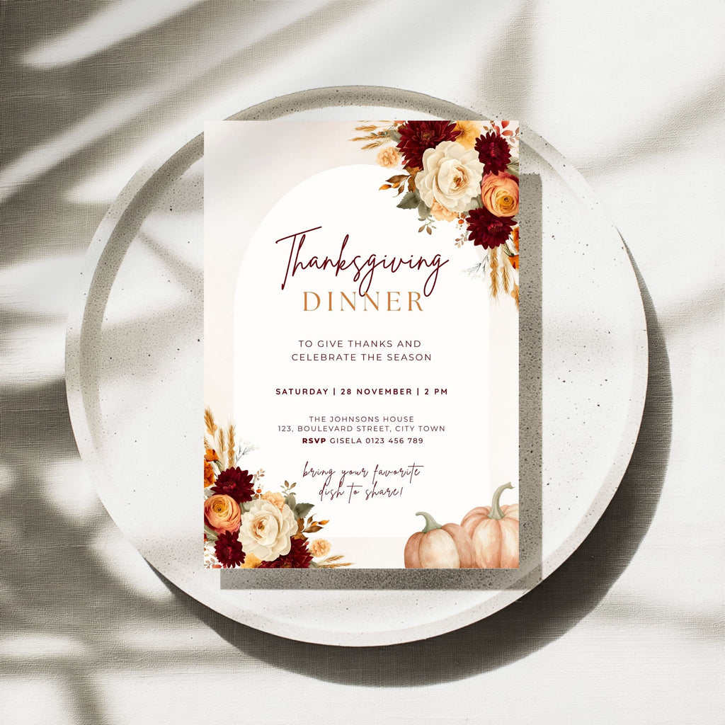 Thanksgiving dinner invitation template with burgundy and orange floral arrangements, pumpkins, wheat accents, elegant typography, and autumn-inspired details on a cream background.