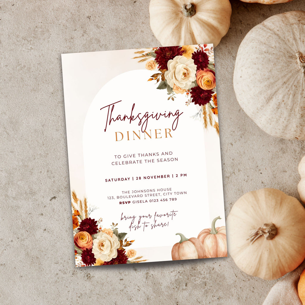 Thanksgiving dinner invitation template with burgundy and orange floral arrangements, pumpkins, wheat accents, elegant typography, and autumn-inspired details on a cream background.
