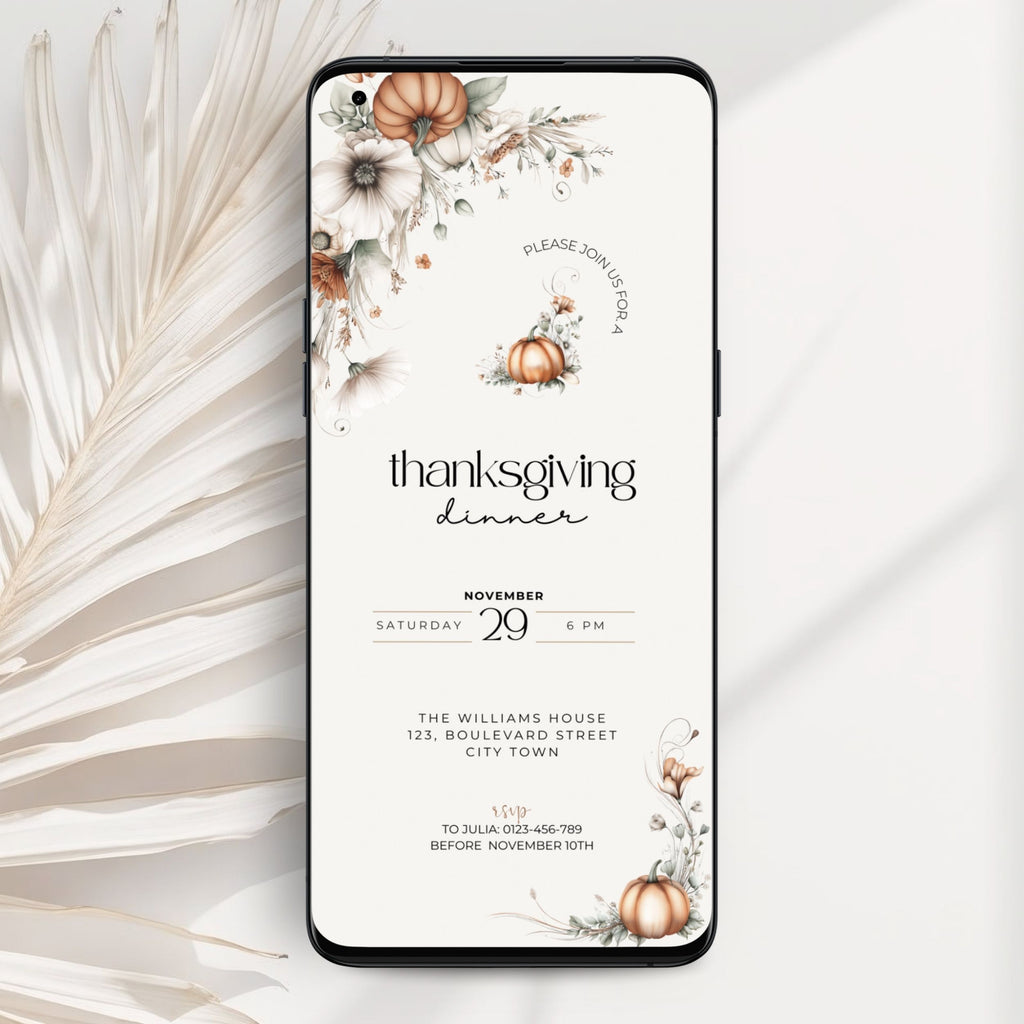 A smartphone case shown from the back on a light neutral background, featuring a Thanksgiving dinner invitation design with floral illustrations, pumpkins, and black text. A dried palm leaf is placed to the left as a styled prop.