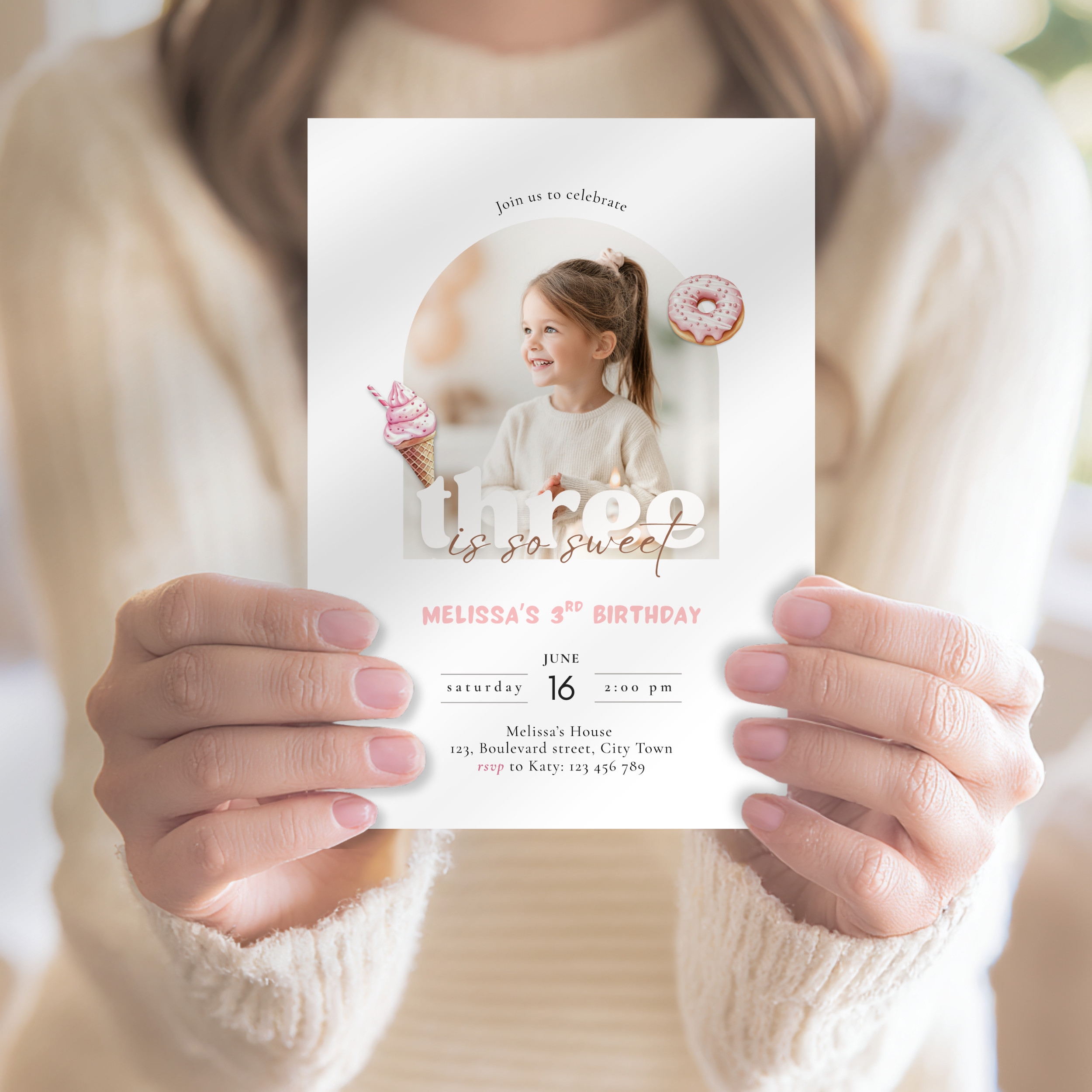 Person holding a birthday invitation card with a photo of a girl and text.