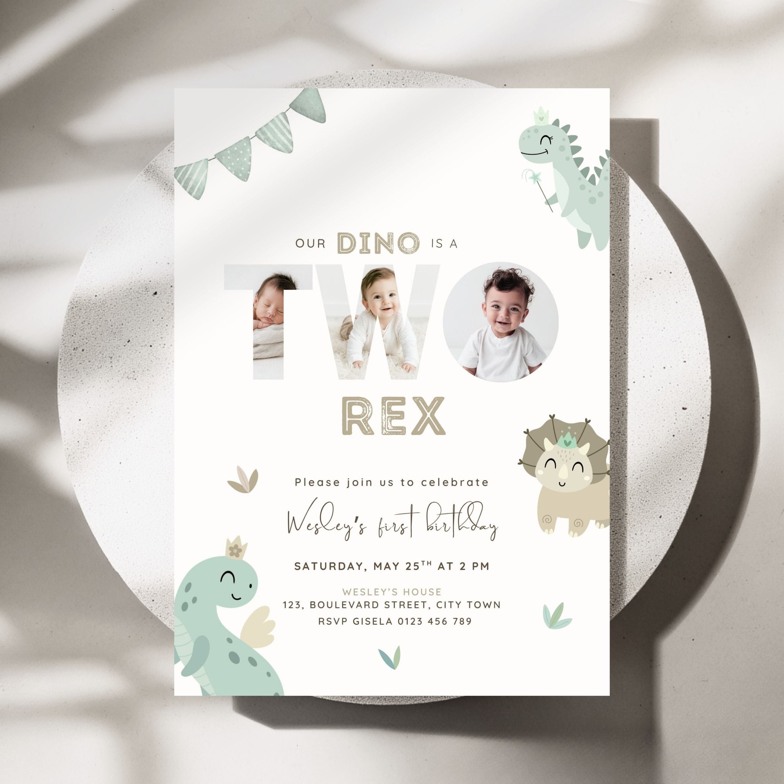 A dinosaur-themed 2nd birthday invitation card displayed on a round white plate. The card features cute cartoon dinosaurs in sage green and beige, with placeholders for photos inside the letters 'TWO' and additional text for a child's first birthday.