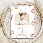 Two sweet birthday invitation card with a photo of a child and donut-themed design on a textured surface.