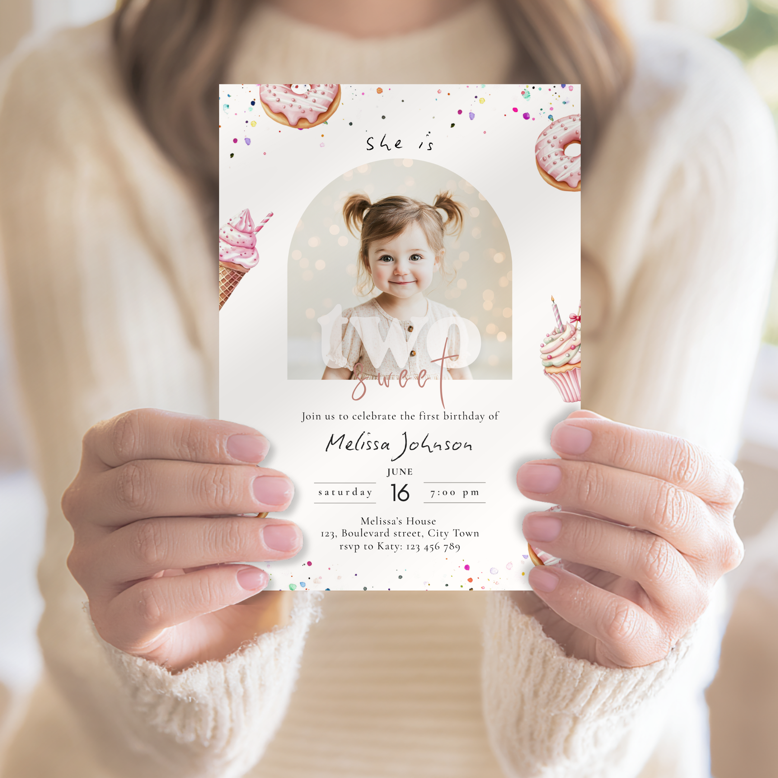 Person holding a two sweet birthday invitation card with a photo of a child.