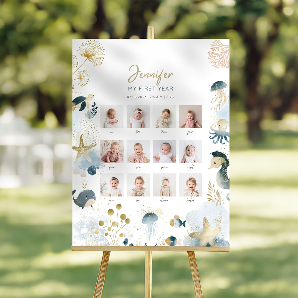 A personalized first birthday reception签到 board displayed on a wooden easel in an outdoor garden setting. The board features a white background decorated with light blue and gold sea-themed illustrations, including jellyfish, starfish, seahorses, and dandelions.
