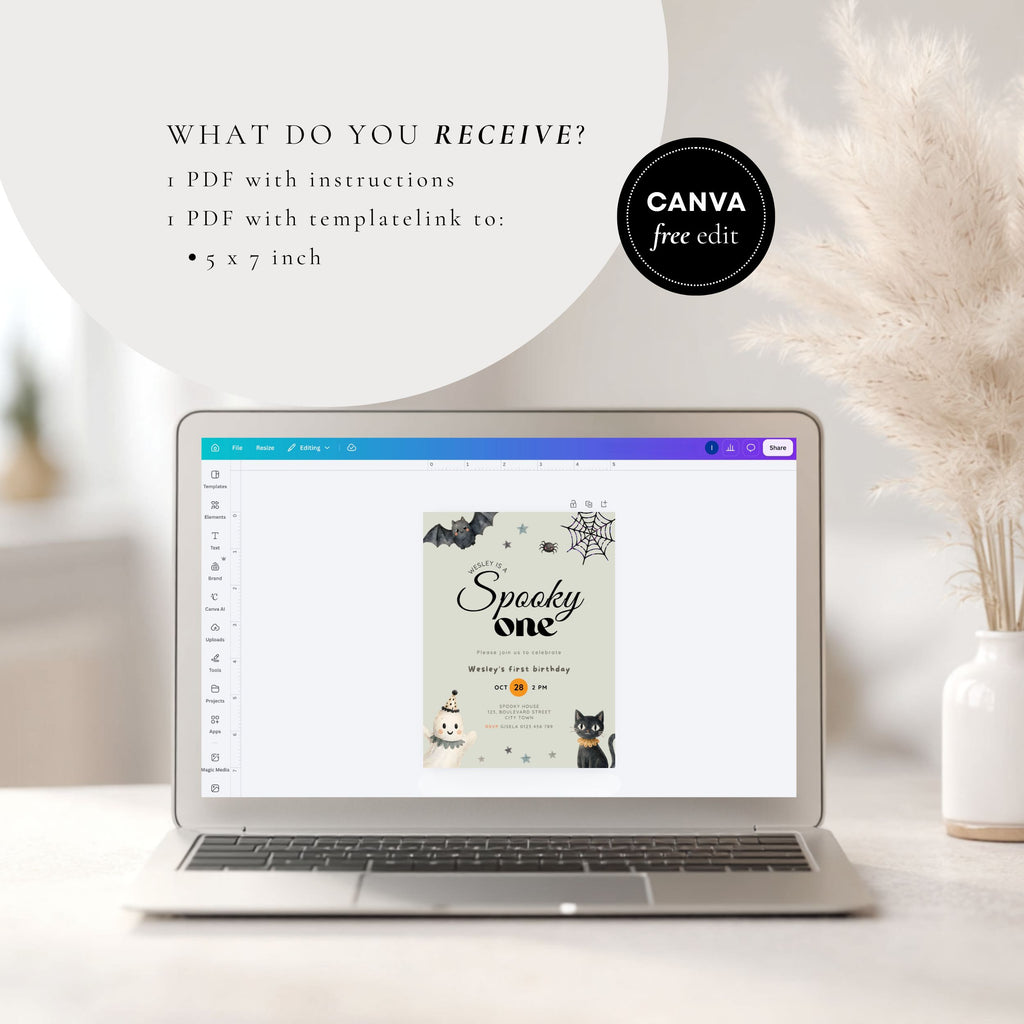A laptop on a light surface displays a digital Canva template for a 'Spooky One' birthday party invitation. Text on the left reads 'WHAT DO YOU RECEIVE?' and a black circular badge says 'CANVA free edit.
